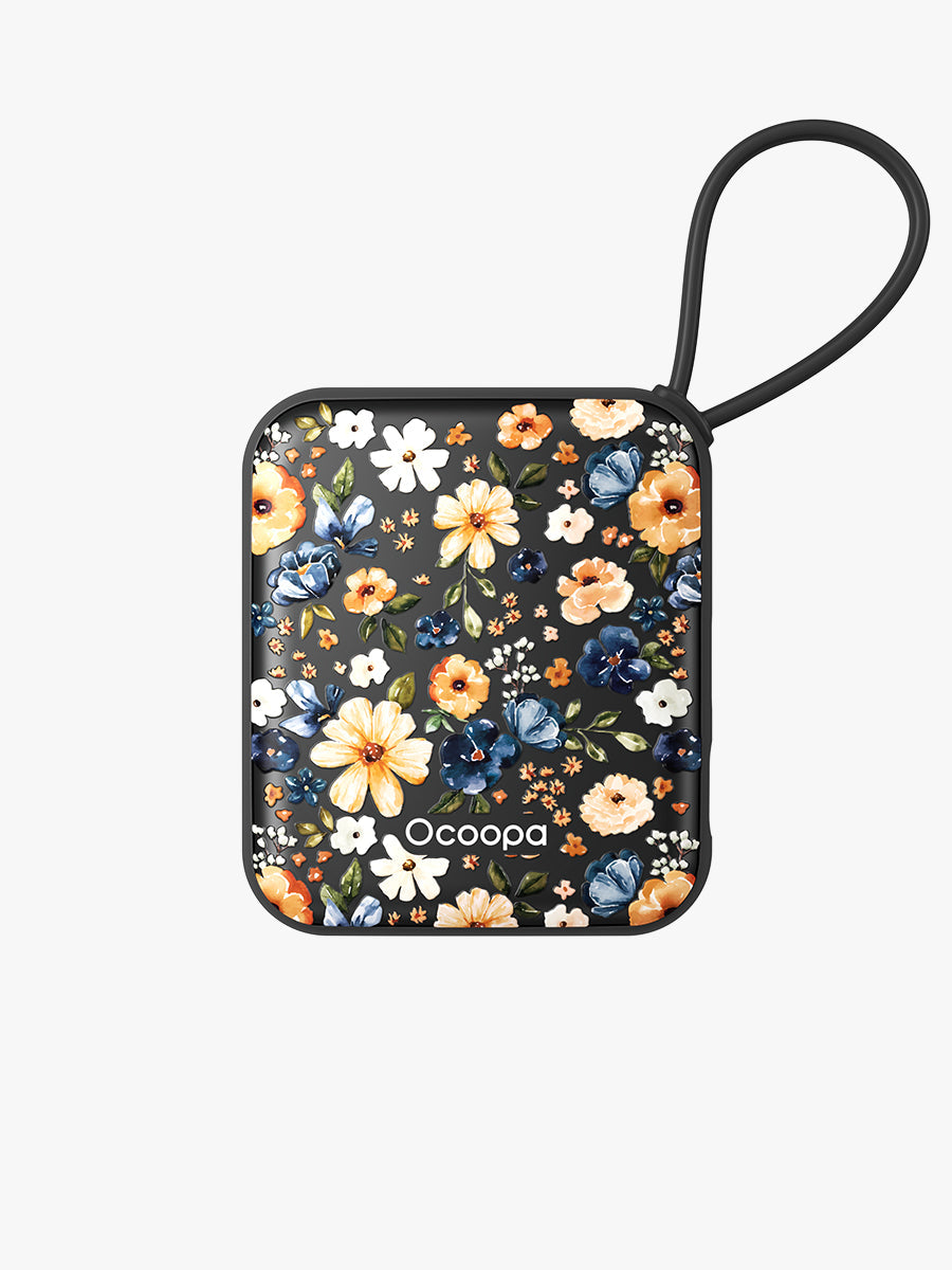 Black floral hand warmer with wrist loop, close-up